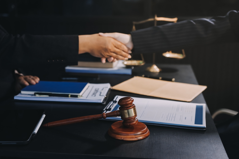 attorney and client shaking hands after case settlement